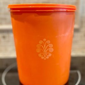 Vintage 1970s era orange Tupperware canister 9 inches high 7 inch base